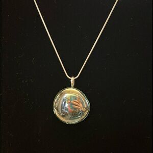 Handcrafted iridescent glass pendant on an 18 inch silver plated snake chain